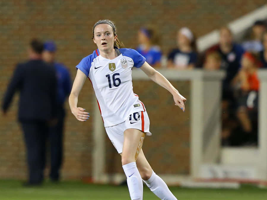 Rose Lavelle Skillfully Maneuvering The Soccer Ball During A Tournament Wallpaper