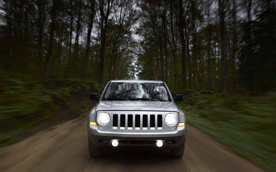 Rugged Jeep Patriot On A Scenic Mountain Adventure Wallpaper