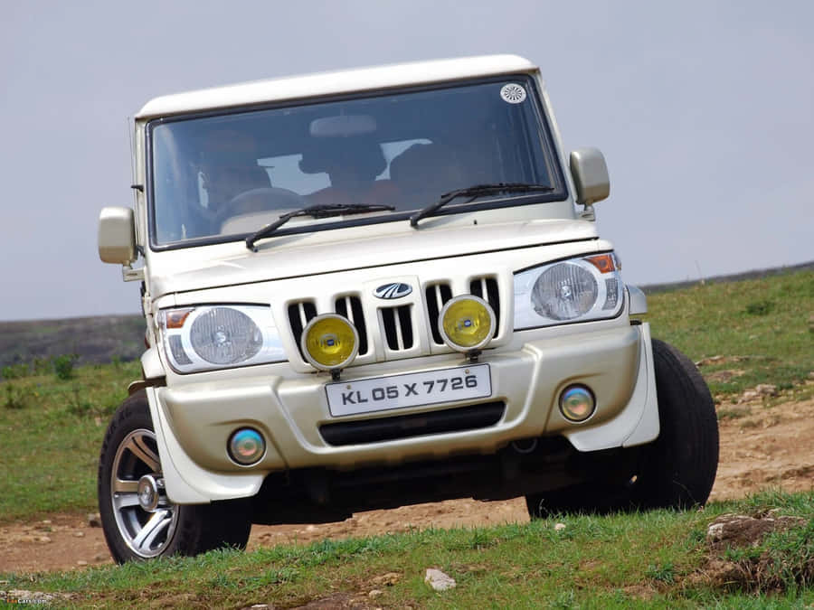 Rugged Red Mahindra Suv In Action Wallpaper