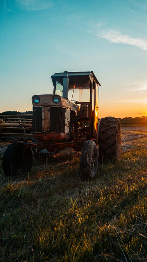 Rustic Tractor At Sunset Wallpaper