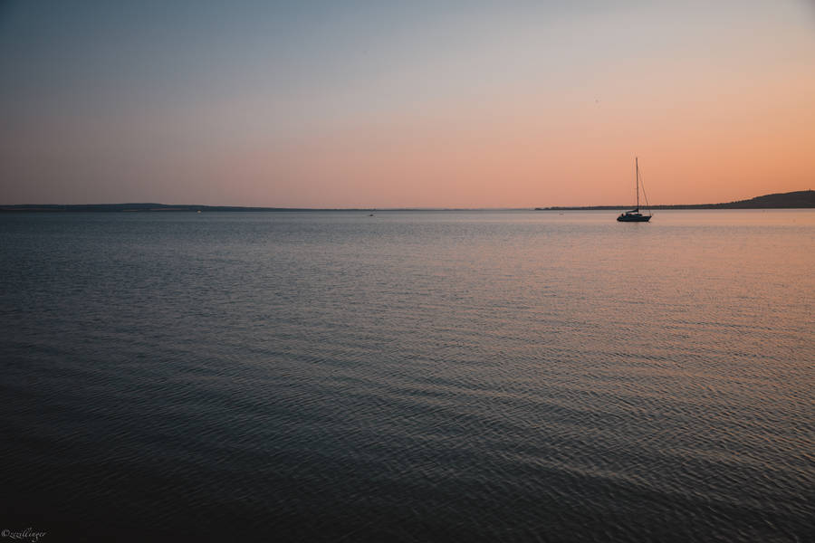 Sailing Alone In Calm Waters Wallpaper