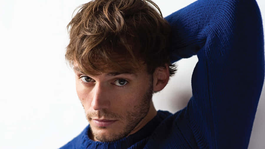 Sam Claflin Looking Thoughtful In A Candid Photoshoot Wallpaper