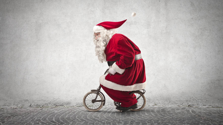 Santa Claus Riding Bicycle Wallpaper