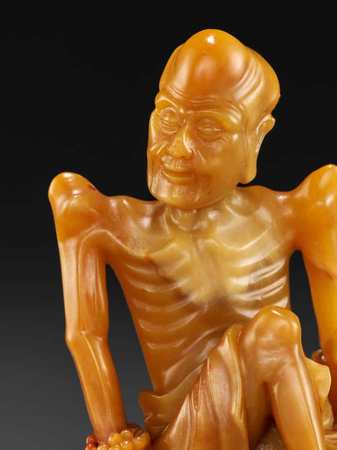 Sculpture Of An Emaciated Old Man Wallpaper