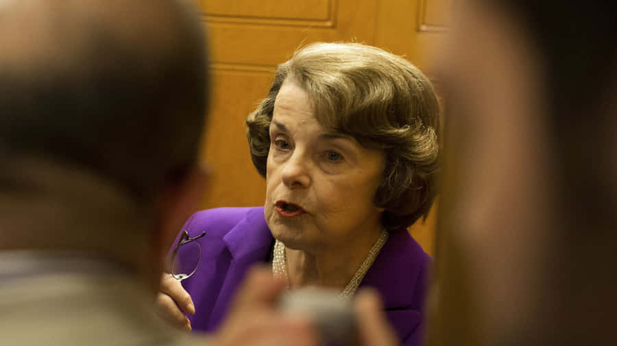 Senator Dianne Feinstein During A Focused Discussion Wallpaper
