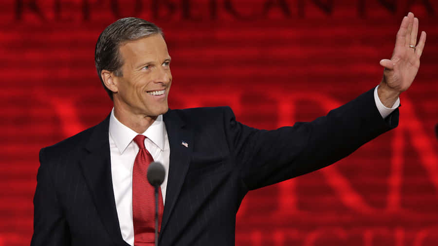 Senator John Thune Posed Against A Red Background Wallpaper