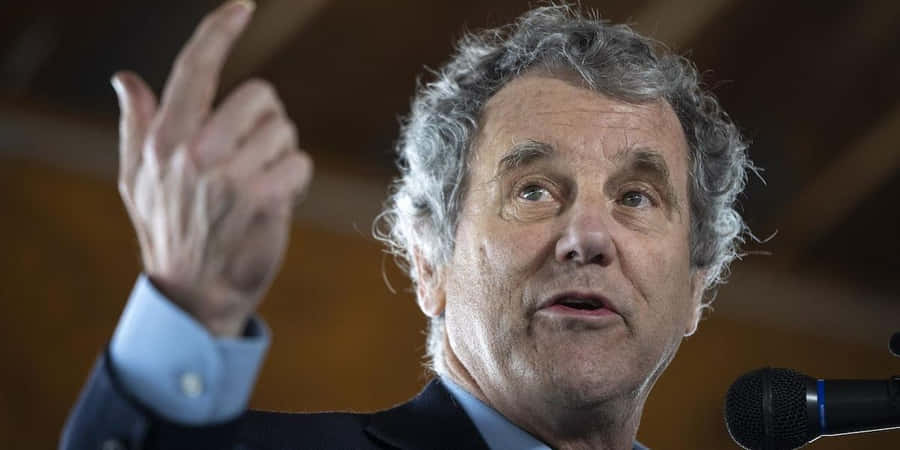 Senator Sherrod Brown Intensely Speaking During A Public Speech Wallpaper