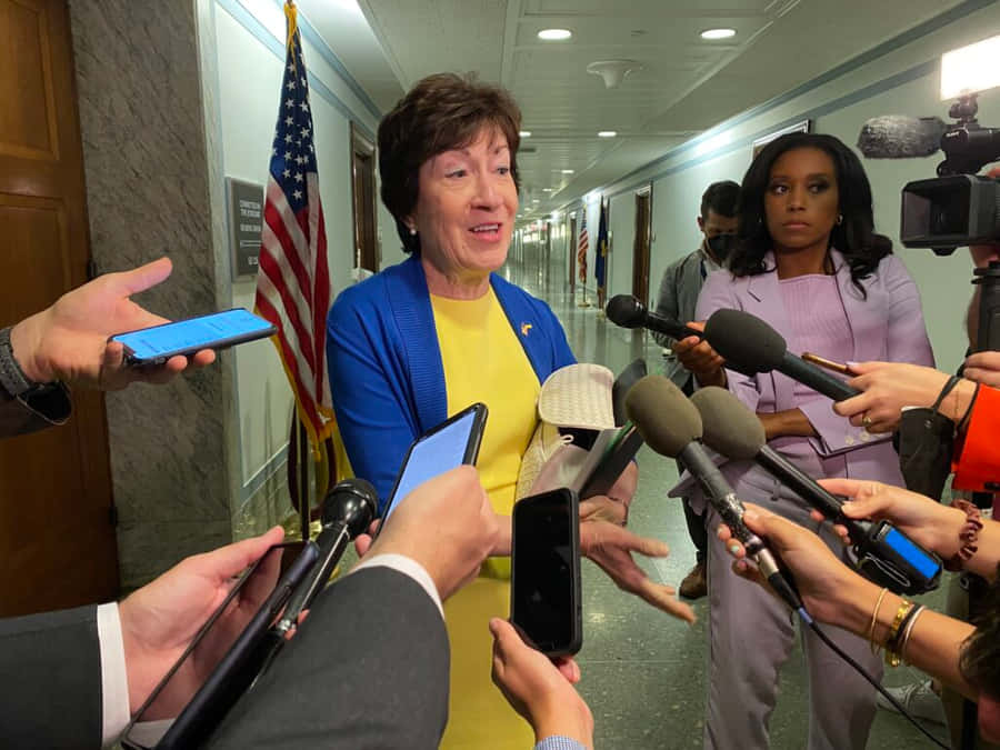 Senator Susan Collins Engaged In A Press Briefing Wallpaper