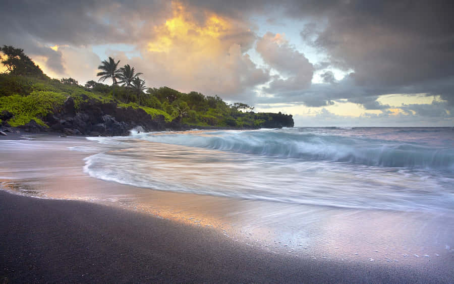Serene Beach Waves Rolling Onto The Shore Wallpaper