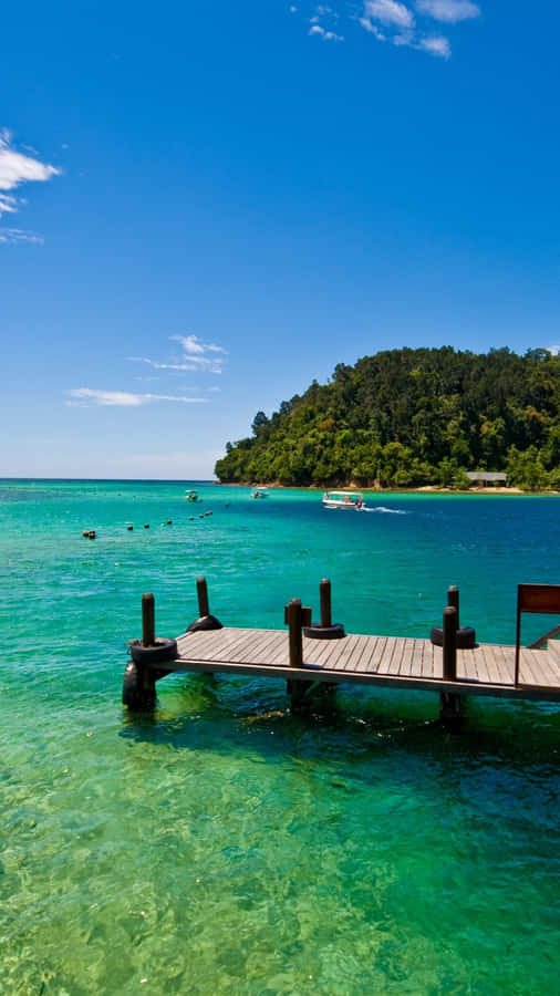 Serene Boating Escape: A Couple Enjoying A Peaceful Ride On A Boat Wallpaper