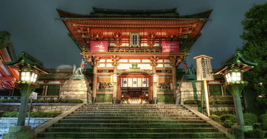 Serene Feudal Japanese Village With Majestic Castle In Background Wallpaper