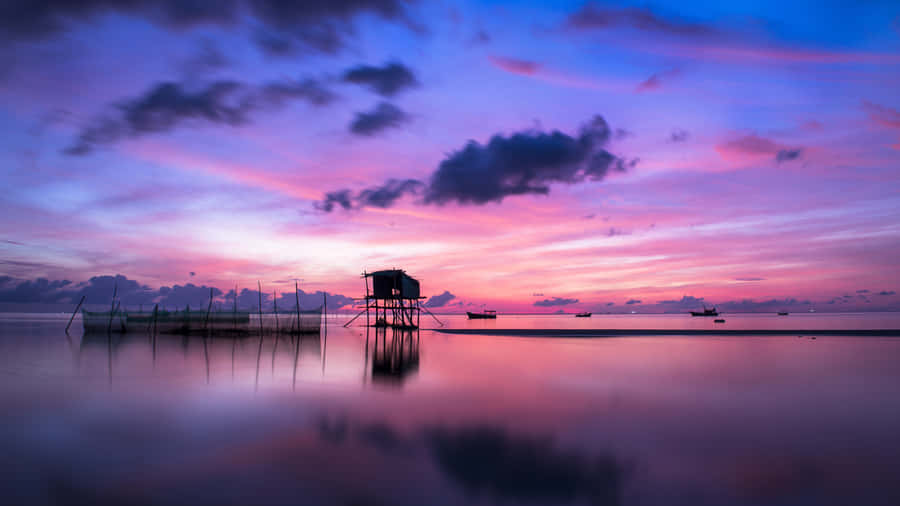 Serene Sunset Over Water Bungalow.jpg Wallpaper