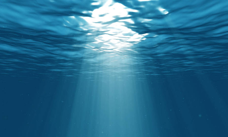 Shining Light Seeping Through A Blue Underwater World Wallpaper