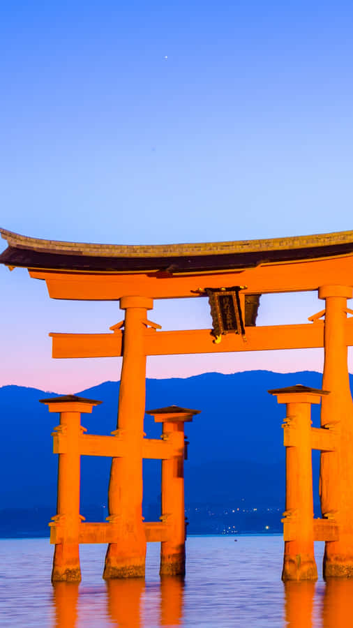 Shinto Torii Gate At Scenic Sunset Wallpaper