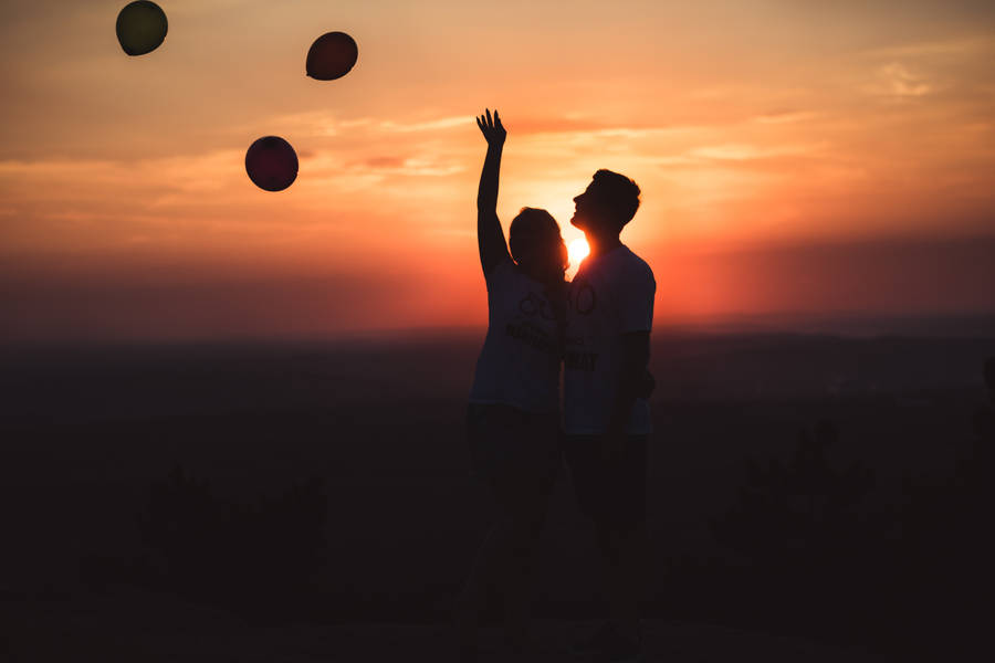 Silhouette Couple Releasing Balloons Wallpaper
