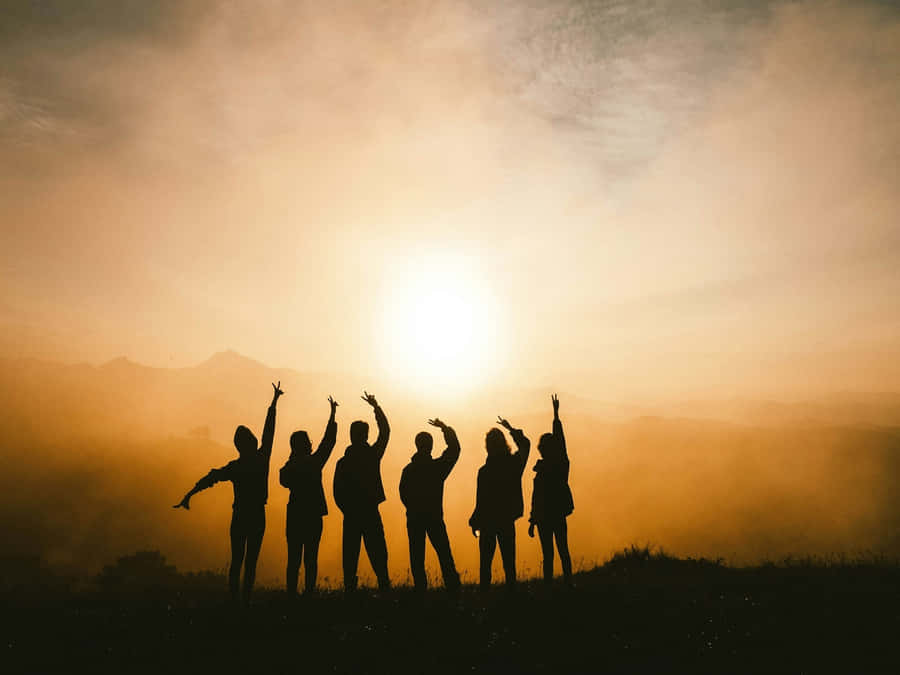 Silhouetted Friends Sunset Celebration.jpg Wallpaper