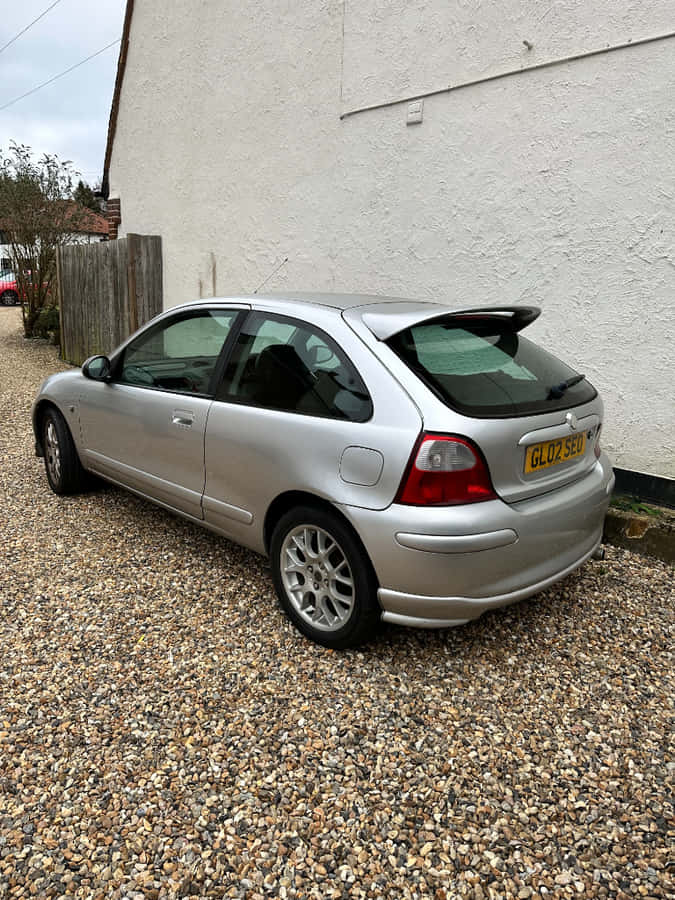 Silver Hatchback Car Parked Gravel Driveway Wallpaper