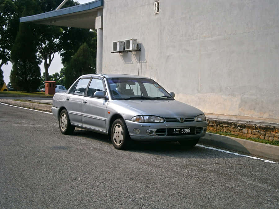 Silver Proton Wira Parked Beside Building Wallpaper