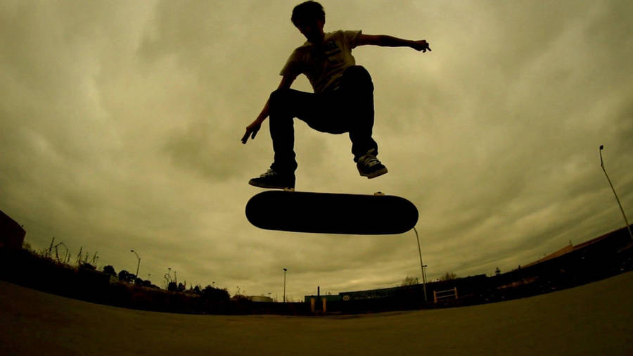 Skateboarder Takes A Big Jump Wallpaper