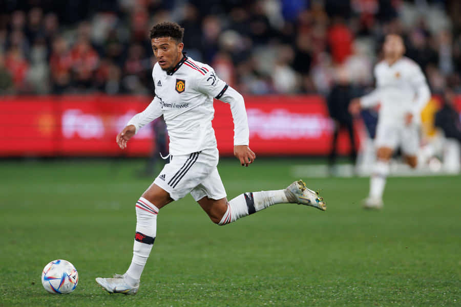 Skillful Soccer Player Performing A Dribbling Move Wallpaper