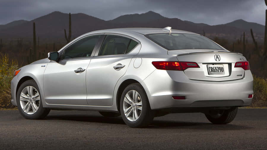 Sleek Acura Ilx Cruising On A Scenic Drive Wallpaper