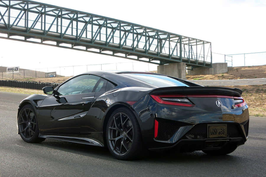 Sleek Acura Nsx Sports Car On The Open Road Wallpaper