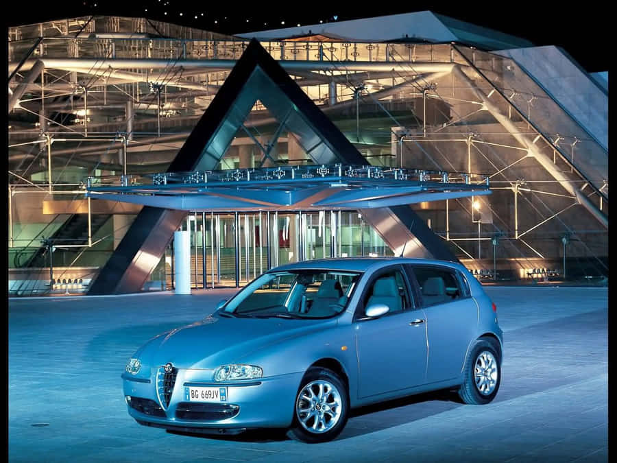 Sleek Alfa Romeo 147 On An Open Road Wallpaper