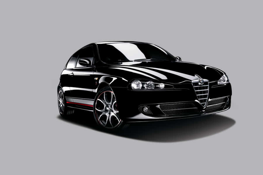 Sleek Alfa Romeo 147 Parked In Style Wallpaper
