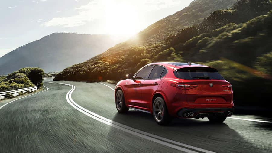 Sleek Alfa Romeo Stelvio In Pristine Condition On Open Road Wallpaper