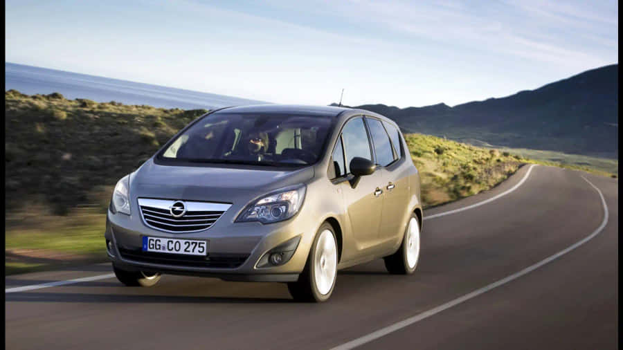 Sleek And Classy Opel Meriva In Modern Cityscape Wallpaper