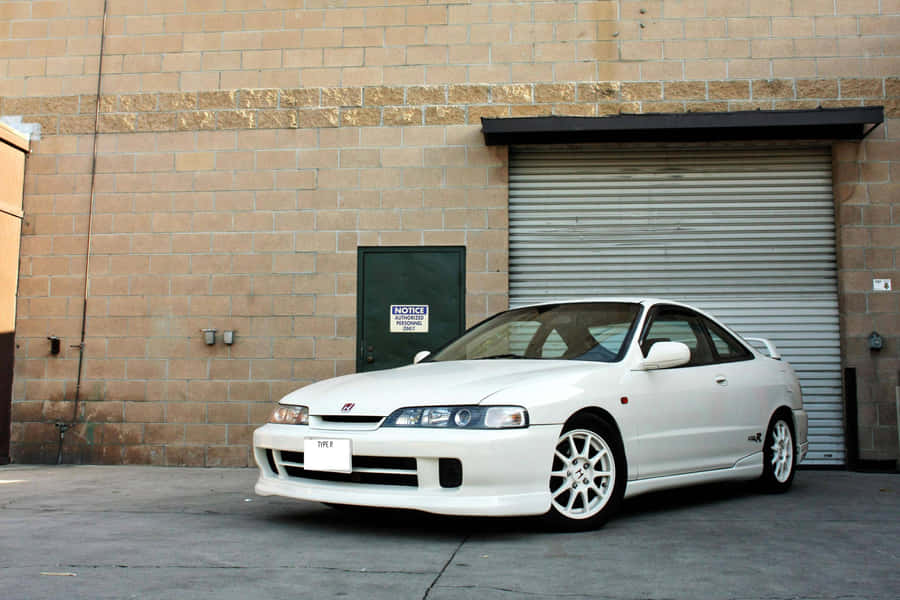 Sleek And Elegant Acura Integra On The Road Wallpaper