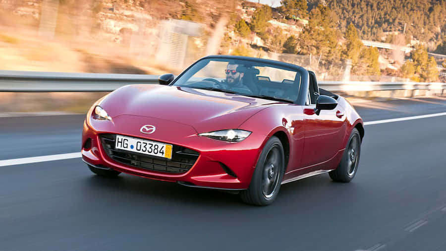 Sleek And Elegant Fiat 124 Spider On The Road Wallpaper