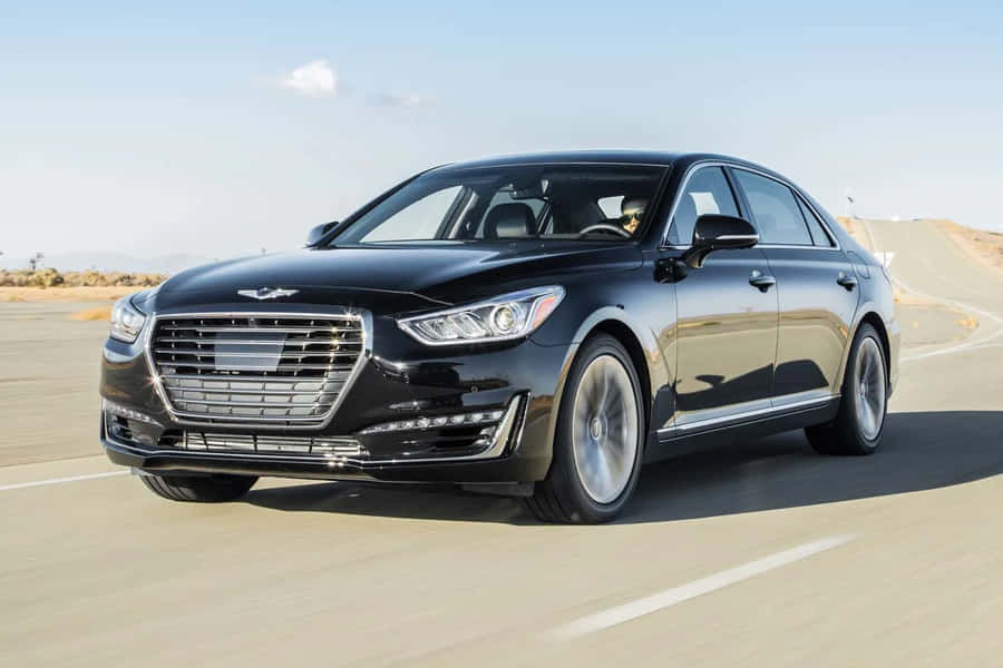 Sleek And Luxurious Genesis G90 Cruising Down The Road Wallpaper