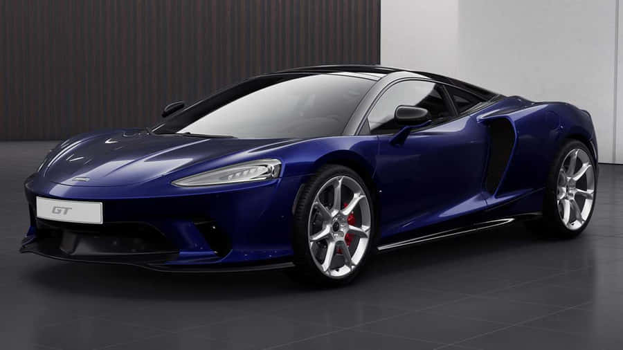 Sleek And Luxurious Mclaren Gt On The Open Road Wallpaper