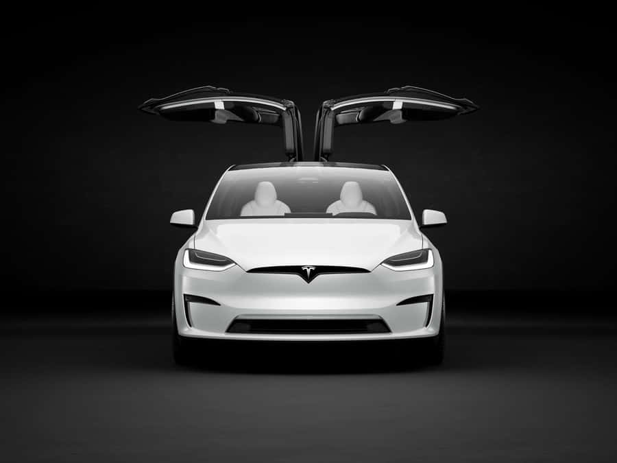 Sleek And Modern Hybrid Car On The Road Wallpaper