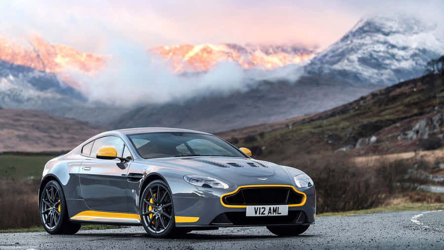 Sleek And Powerful Aston Martin V12 Vantage On The Road Wallpaper