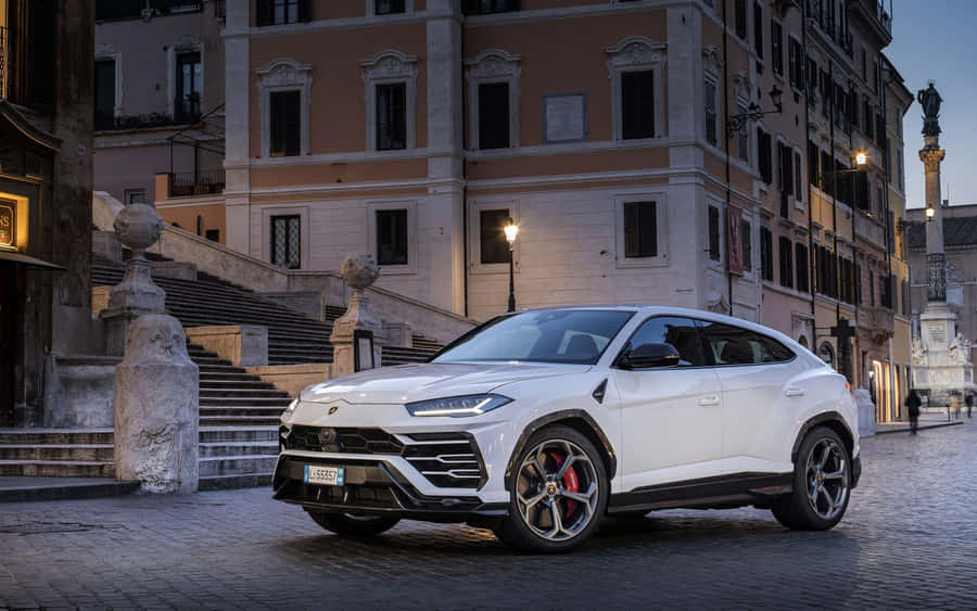 Sleek And Powerful Lamborghini Urus Suv In Action Wallpaper
