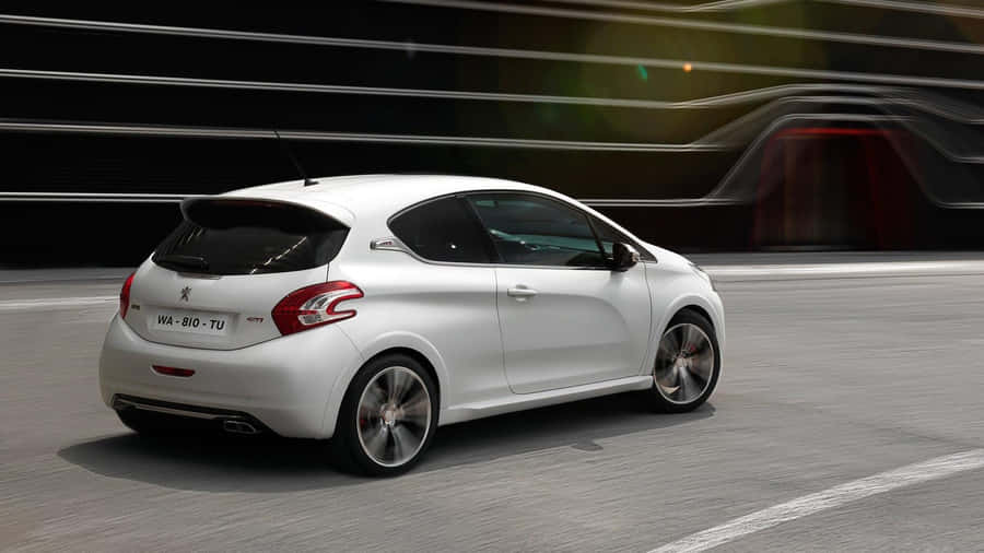 Sleek And Sophisticated Peugeot 208 On The Open Road Wallpaper