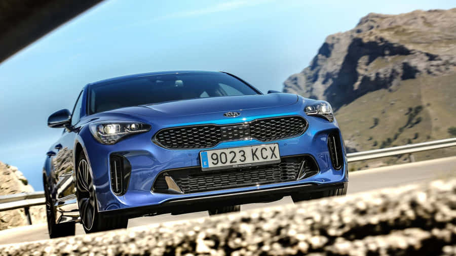 Sleek And Sporty Kia Stinger On The Open Road Wallpaper