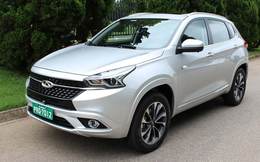 Sleek And Stylish Chery Car In Action Wallpaper