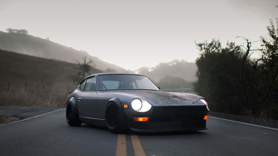 Sleek And Stylish Datsun On The Road Wallpaper