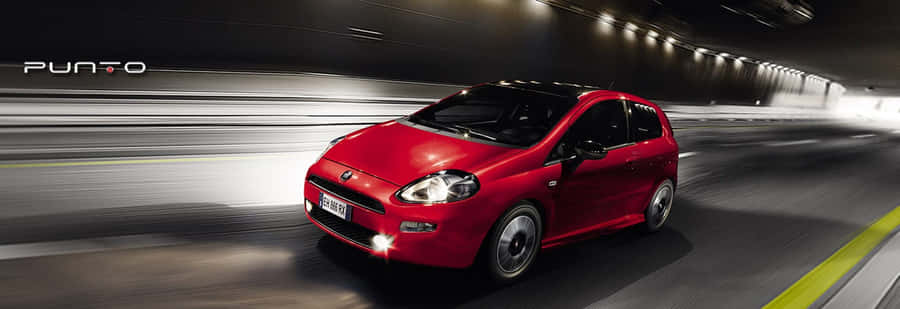 Sleek And Stylish Fiat Punto On The Road Wallpaper