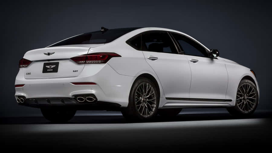 Sleek And Stylish Genesis G80 In A Nighttime Setting Wallpaper
