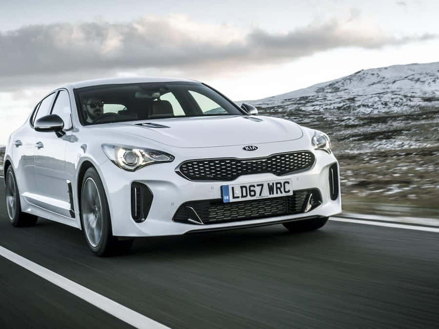 Sleek And Stylish Kia Stinger On The Open Road Wallpaper