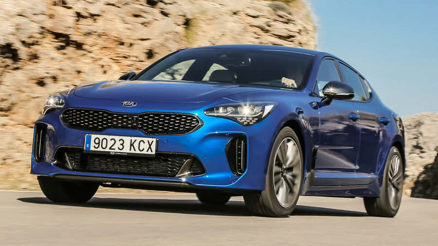 Sleek And Stylish Kia Stinger On The Road Wallpaper