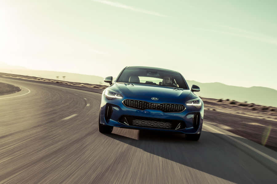 Sleek And Stylish Kia Stinger On The Road Wallpaper