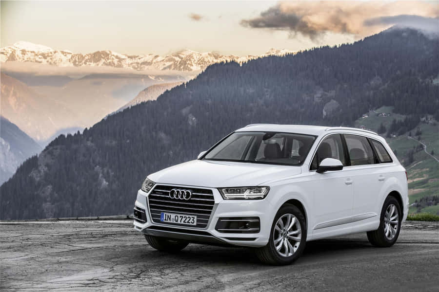 Sleek Audi Q7 In Striking Nighttime Setting Wallpaper