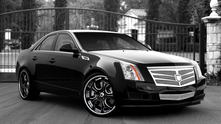 Sleek Black Cadillac Cts On The Road Wallpaper
