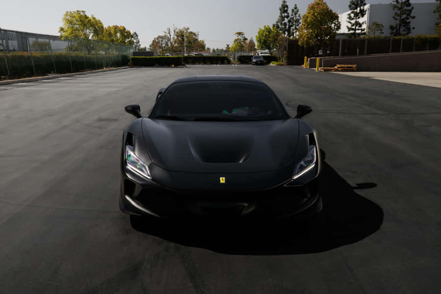 Sleek_ Black_ Sports_ Car_ Parked_ Outdoors.jpg Wallpaper