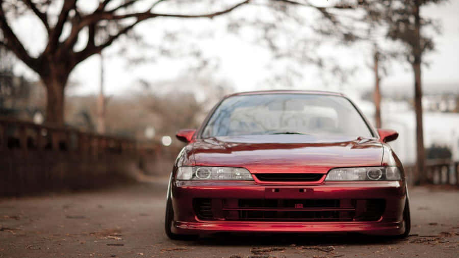 Sleek Blue Acura Integra Sportscar On A Highway Wallpaper